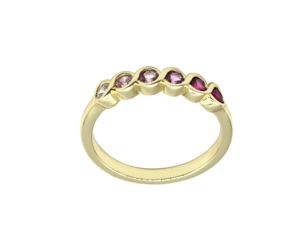 Gold ring with embedded gemstones on a white background
